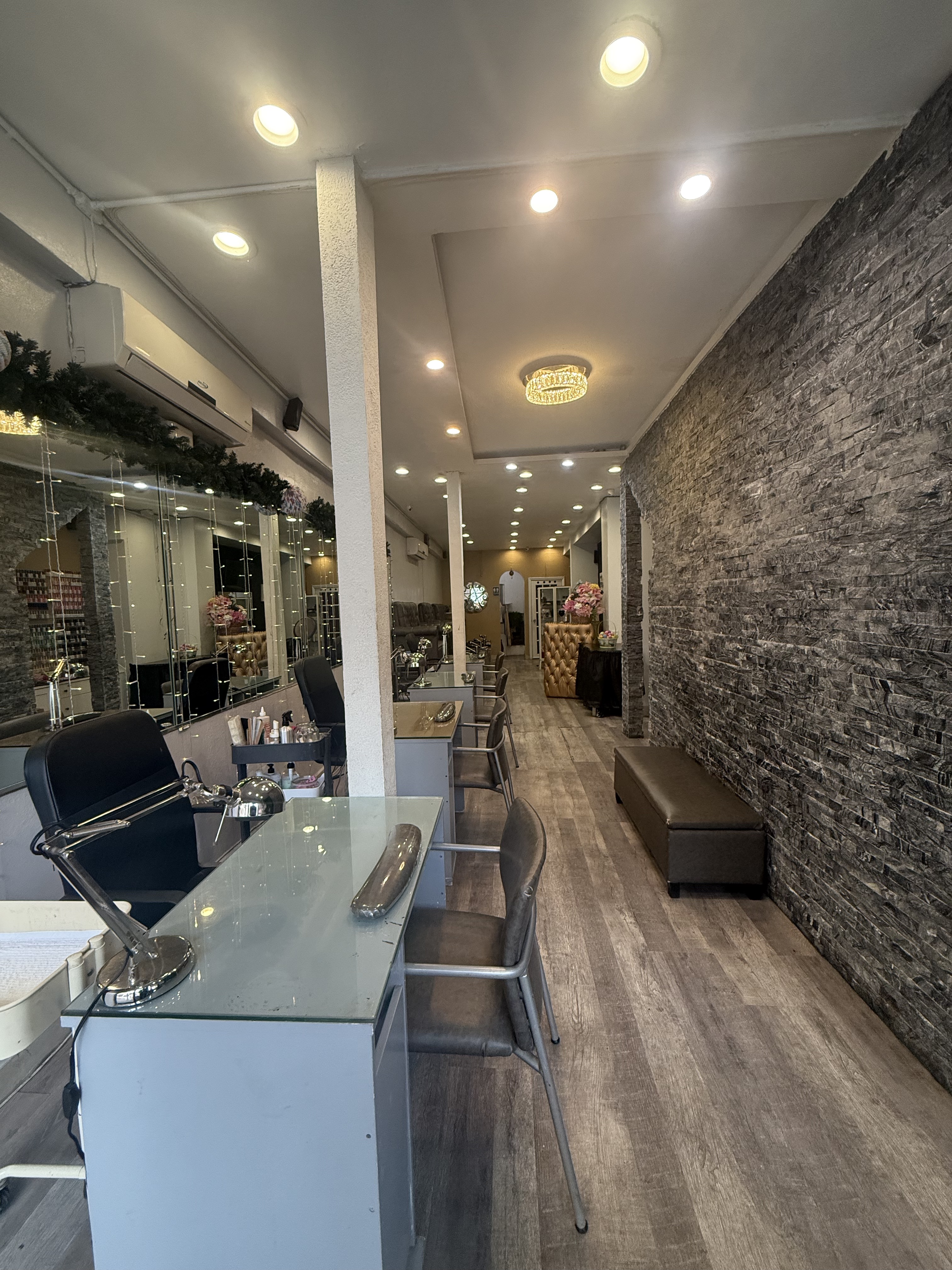 Inside D'Ana's Nails & Spa salon — manicure stations, warm lighting, and a welcoming atmosphere in the Bronx, NY
